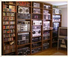 a room filled with lots of different types of radio equipment and bookshelves full of cds