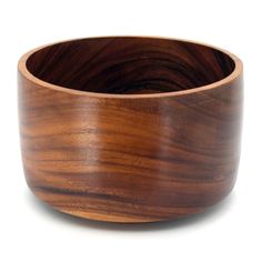 a wooden bowl sitting on top of a white surface