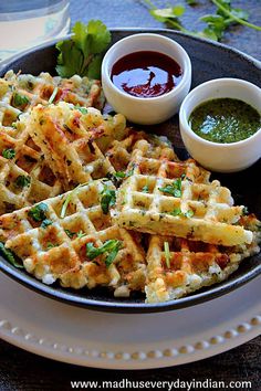 a plate with waffles and dipping sauce on it