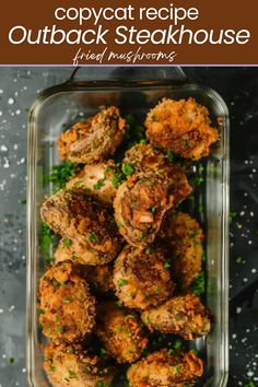 an overhead view of some fried meats in a glass dish with parsley on the side