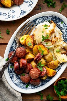 two plates filled with potatoes and meat on top of a wooden table