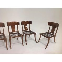 three wooden chairs sitting next to each other