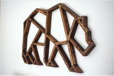 a wooden sculpture is hanging on the wall