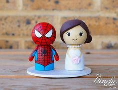 a wedding cake topper with a bride and spider man