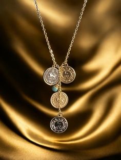 The Pahlavi Coin Necklace is a stunning piece of jewelry that beautifully merges history with elegance. Adorned with four Old Fashion Yek Geroonie coin style pendants, two coin in silver color and two coin in gold color. This necklace is a true representation of the rich cultural heritage of Persia. Each pendant is carefully crafted in 18k gold plating and silver plating, adding a touch of luxury and sophistication to the necklace. The intricate details and design of the coins make it a unique a