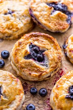 baked blueberry pies with fresh blueberries on top