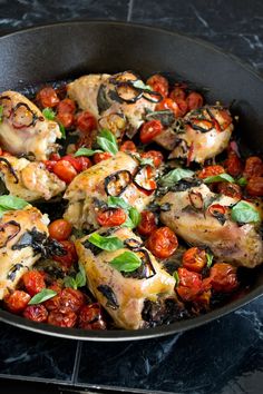 chicken with tomatoes and basil in a skillet