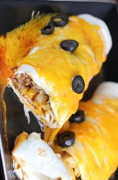 two burritos with cheese and black olives