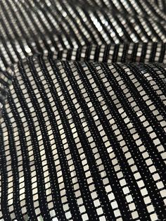 "Good quality and fast shipping." Angela K. Verified Kikitextiles Customer ✅ Bring on the shimmer with our very sparkly Metallic Flat Sequins on Black Glittery Knit. At full glimmer, this medium-weight sequined fabric is a 4 way stretch. Fully opaque, this fabric doesn't require a lining.This fabric is made up of a combination of materials including nylon spandex and sequins. The fabric has a shiny, reflective surface due to the presence of small mirror-like sequins that are attached to it. The Shiny Metallic Sequin Fabric For Evening, Metallic Shiny Sequin Fabric For Evening, Glamorous Sparkling Metallic Sequin Fabric, Metallic Sequin Fabric With Shimmer For Evening, Metallic Shimmer Sequin Fabric For Evening, Sparkling Metallic Sequin Fabric For Night Out, Glamorous Metallic Sequin Fabric With Glitter, Glamorous Metallic Shiny Sequin Fabric, Glamorous Metallic Sequin Fabric