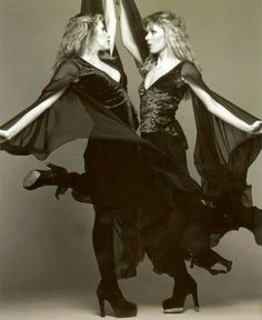 two women dressed in black are dancing