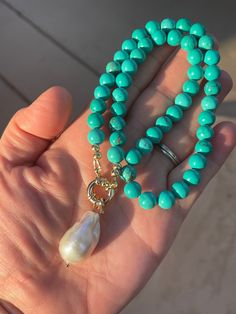 This necklace features beautiful 8mm round greenish-blue reconstituted turquoise, ending in a 14K gold-filled nautical clasp and featuring a large, 30mm white flameball baroque pearl with rainbow-hued nacre.  Please select your length from the drop-down menu. Your jewelry will come gift-boxed, and gift-wrapping is available upon request.  Thanks for checking out my shop! Elegant Turquoise Necklace With Lobster Clasp, Ethiopian Opal Earrings, Moonstone Drop Earrings, Pearl Charm Necklace, Black Pearl Necklace, White Pearl Necklace, Baroque Pearl Necklace, Gemstone Beaded Necklace, Purple Pearl