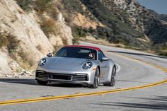 a silver sports car driving down the road