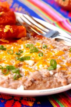 a close up of a plate of food on a table with a fork and knife