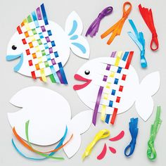 cut out paper fish and scissors on a white surface