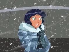 a woman standing in the snow with her hand up to her face