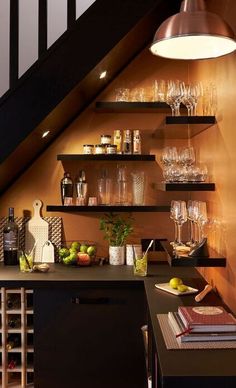 a wine rack under the stairs in a home