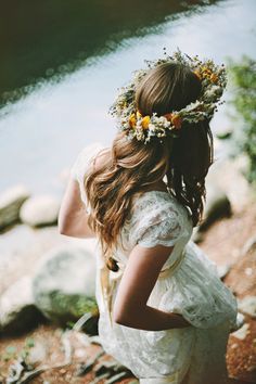 a girl with flowers in her hair is looking at the camera and has an instagram