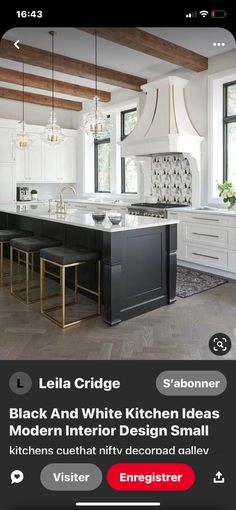 a kitchen with white cabinets and black countertops, an island in the center is surrounded by gold accents