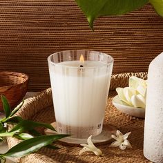 a white candle sitting on top of a table