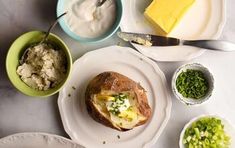 a table topped with plates and bowls filled with different types of food next to each other