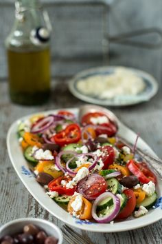 a salad with olives, tomatoes and feta cheese