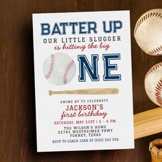 a baseball bat and ball on a wooden table next to a card that says, batter up our little slugger is hitting the key one