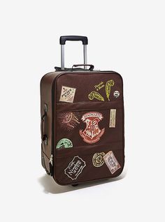 a piece of brown luggage with harry potter stickers on the front and back side