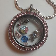 New Mom Floating Locket Pendant In Silvertone With Pink Rhinestones All Around And All New Baby Boy Charms; Boy With Blue Heart, Abc Blocks, Rattle, Bright Color Stones. Permanent Charms. Never Worn. 24" Chain Plus Extender. Metal Hangtag Present. C Clasp. Vg+ Condition. Silver Locket Jewelry For Birthday Gift, Silver Jewelry With Removable Charms For Birthday, Abc Blocks, Origami Owl Lockets, Origami Owl Jewelry, Floating Lockets, Color Stones, New Baby Boys, Origami Owl