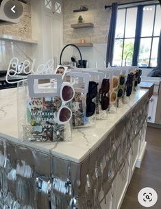 a counter top with glasses and other items on it in a room that looks like a kitchen