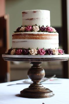 a three tiered cake with flowers on it