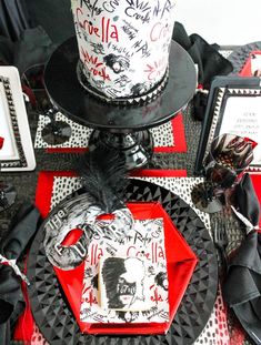 a black and red table topped with a cake