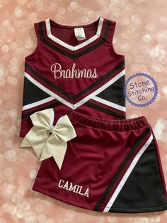 a maroon and black cheerleader outfit with a bow on the side that says, bahoms