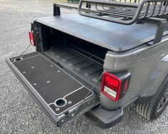 the back end of a pickup truck with its cargo compartment open