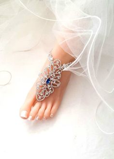 Something Blue Wedding Jewelry,Wedding Barefoot Sandals,Bridal Foot Jewelry,Rhinestone Silver Foot Jewelry,Footless Sandal,Beach Sandals-SD032 This stunning Blue color rhinestone footless sandals is the perfect accessory for a beach or garden wedding. This sandal has colored rhinestones in the center and clear rhinestones around it. It is very comfortable and adjustable. Silver Model Size is US 7.5 Sandals are made with the rhinestone with Silver plating. Quantity: One order is one pair (2 pcs). Elegant Crystal Sandals For Wedding, Elegant Crystal Wedding Sandals, Crystal Open Toe Sandals For Wedding, Silver Toe Ring Sandals For Wedding, Blue Summer Wedding Jewelry, Blue Open Toe Barefoot Sandals For Party, Adjustable Rhinestone Barefoot Sandals For Wedding, Blue Bohemian Barefoot Sandals For Beach, Blue Foot Jewelry