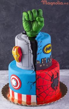 a birthday cake decorated with the hulk and spider - man symbols