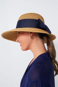 Toucan Hats makes our best-selling and beloved beach accessories.This bow-trimmed hat offers pretty protection from the sun with a nautical navy ribbon detail. Wear to the beach with your favorite caftan for a classic, feminine, and practical finishing touch. The best part? It's packable so it will easily fit in your suitcase or weekender, and keeps its shape after you pull it out. Wide brim Navy bow detail Packable Material: Woven Straw Navy Hat For Spring, Navy Beach Hat, Elegant Lightweight Boater Hat For Beach, Chic Sun Hat With Bow For Vacation, Chic Vacation Sun Hat With Bow, Beach Straw Boater Hat With Bow, Vacation Boater Hat With Bow And Short Brim, Straw Hat With Bow For Vacation, Elegant Beach Hats With Bow