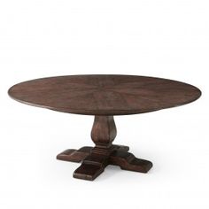 an oval wooden table with four pedestals on one end and two leaves on the other