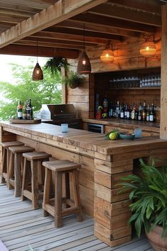 an outdoor bar with stools and bottles on it