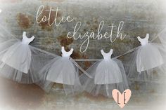 three tulle dresses hanging on a clothes line with the words little elizabeth above them