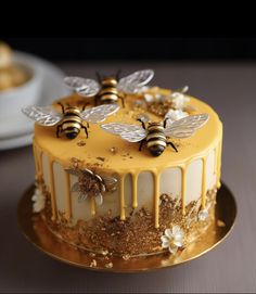 a cake decorated with bees and flowers on a plate