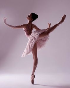 a ballerina in a pink tutu and ballet shoes