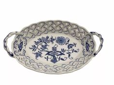 an ornate blue and white bowl with handles