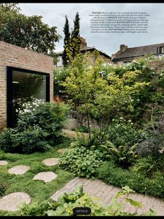 an outdoor garden with stepping stones and grass