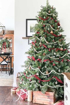 a decorated christmas tree with red and white ribbons