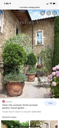 an image of a house with flowers in the front yard and on the back wall