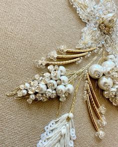 the brooch is decorated with pearls and other things to wear on her wedding day