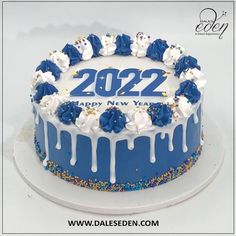 a blue and white birthday cake decorated with sprinkles, frosting and the number 2052