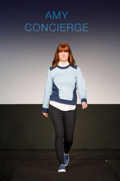 a woman is walking down the runway