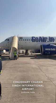 a man standing in front of an airplane on the tarmac