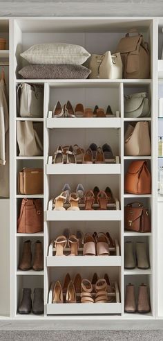 a white closet filled with lots of different types of shoes and purses on shelves